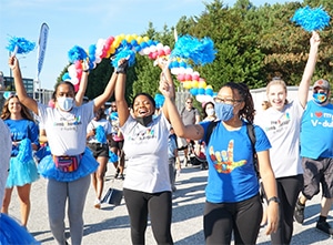 A group of women cheering while participating in the united services autism walk