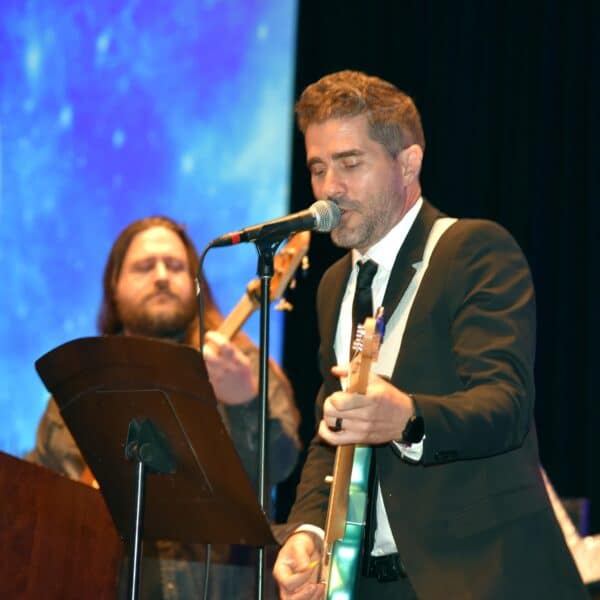 Two members of a band performing music at the annual gala