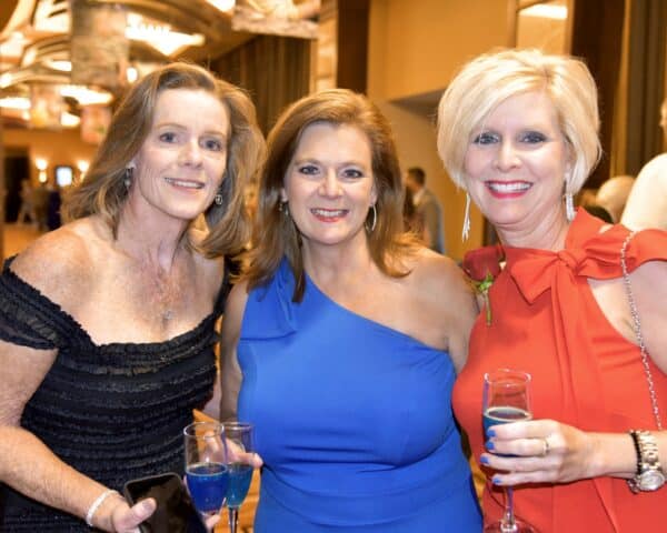 Three smartly dressed women at the annual United Services fundraising gala
