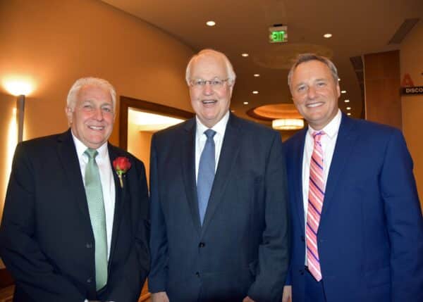 Three smartly dressed men at the annual United Services fundraising gala