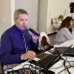 the host of our trivia night holding a microphone