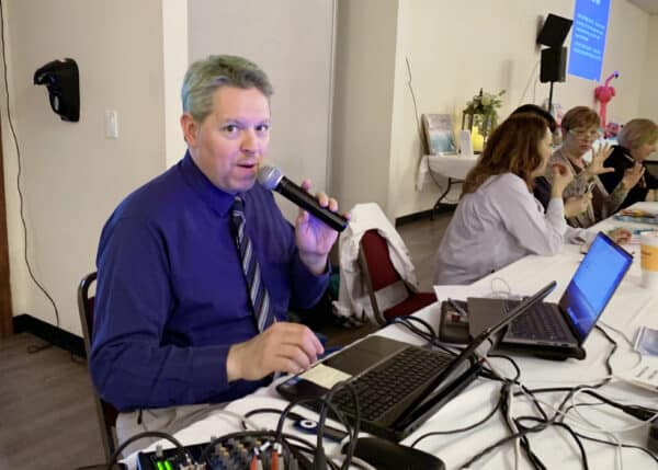 the host of our trivia night holding a microphone